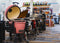 The interior of a grill store with a lineup of gas and pellet fueled smokers and grills and accessories and smoking fuel in the background